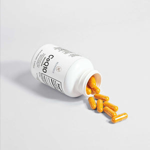 MIANIMED Premium skincare CoQ10 supplement bottle with capsules spilling out, product on a white background.