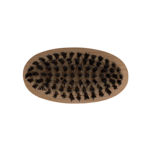 Oval wooden brush with dense black bristles for MIANIMED premium skincare routines.