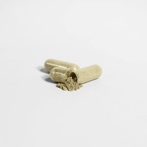 MIANIMED premium skincare capsules with herbal powder on white background.