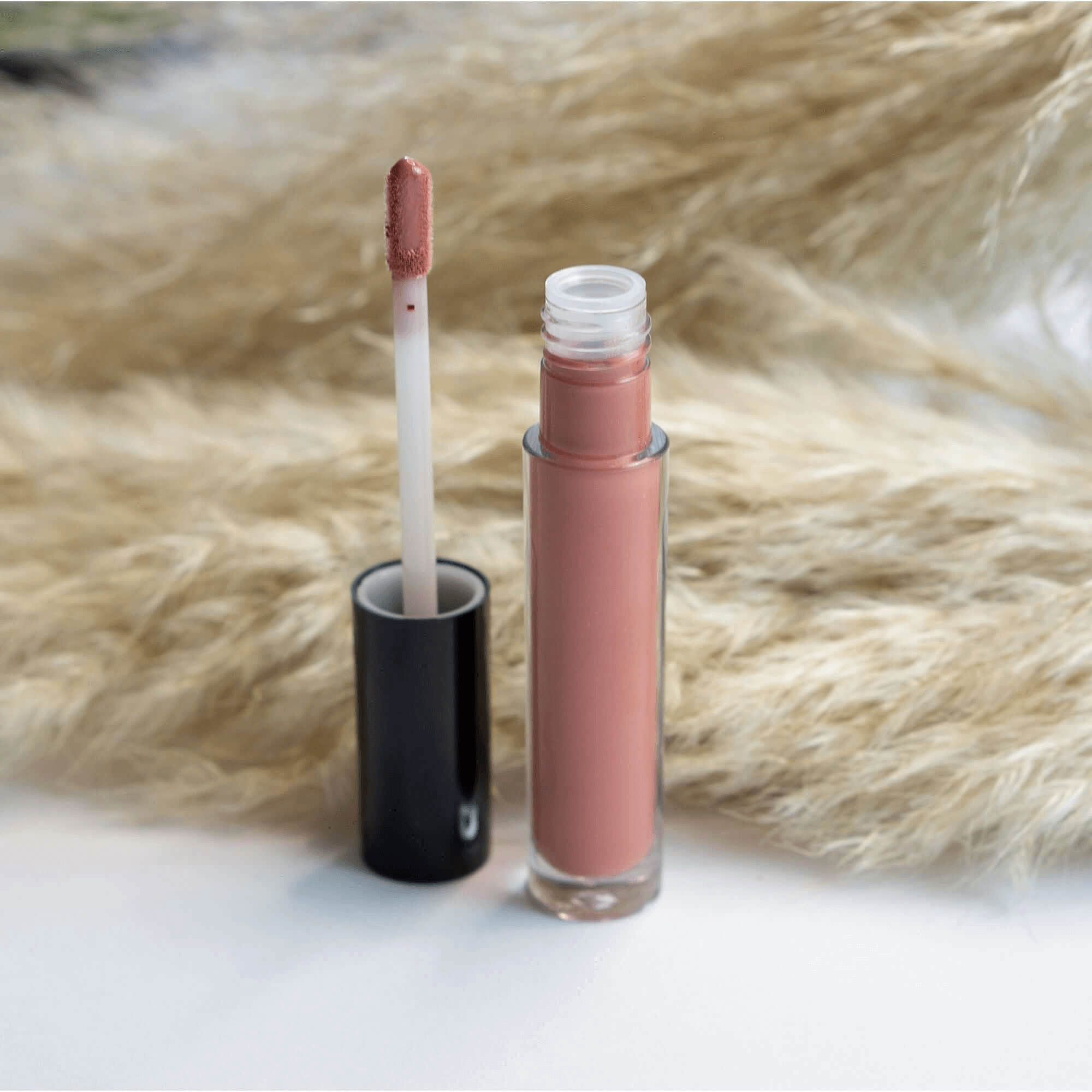 MIANIMED Premium skincare lip gloss with applicator against pampas grass background for enhanced beauty and hydration