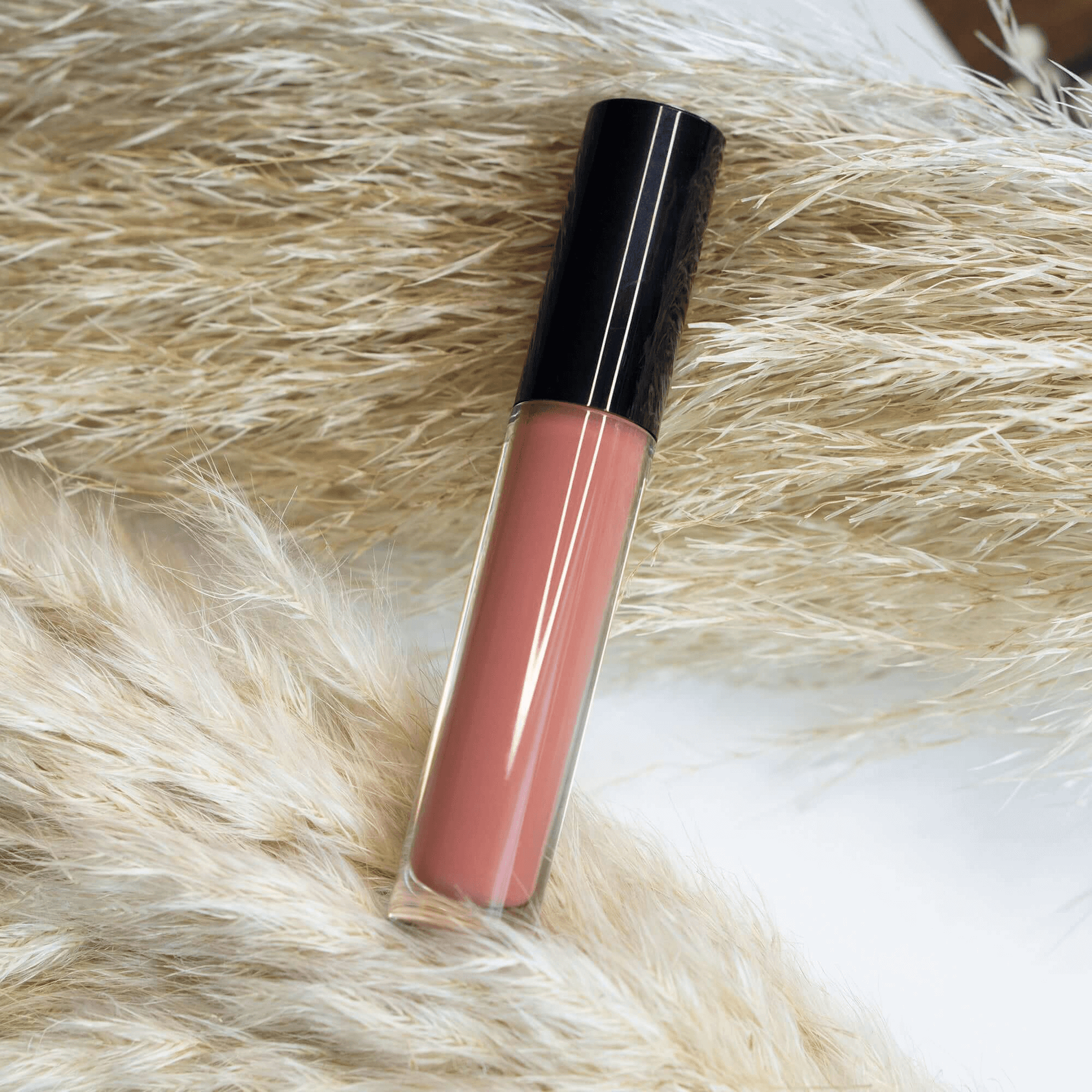 MIANIMED premium skincare lip gloss tube on soft fur background