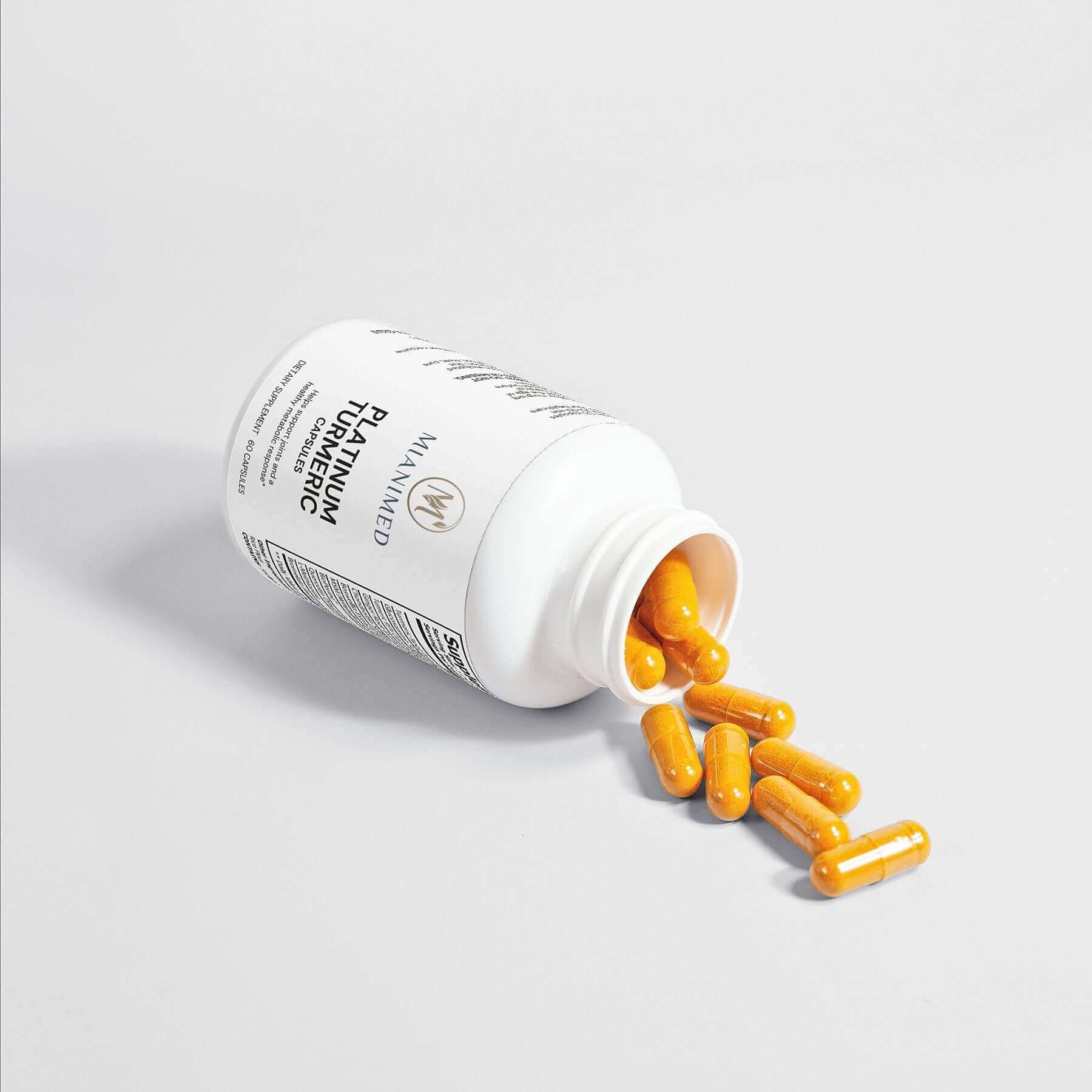 MIANIMED Premium skincare supplement capsules spilled from white bottle.